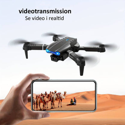 "4K UHD drone med dobbelte kameraer, lang flyvetid, grå design, perfekt til professionelle og hobbyfotografer."