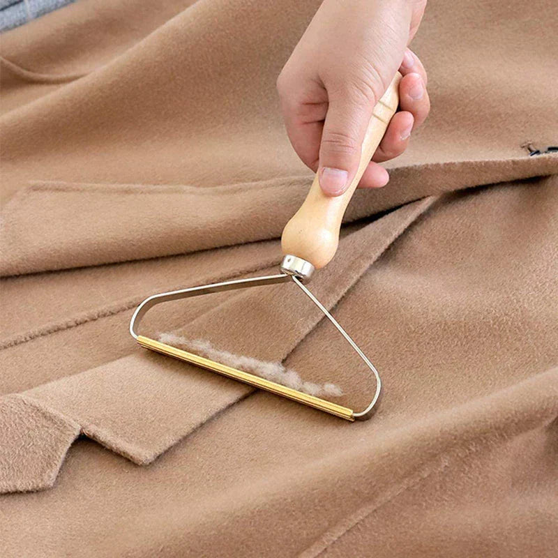 "Effektiv håndholdt fnugfjerner, kompakt design, miljøvenlig, fjerner fnug og dyrehår fra tøj, tæpper og sengetøj."