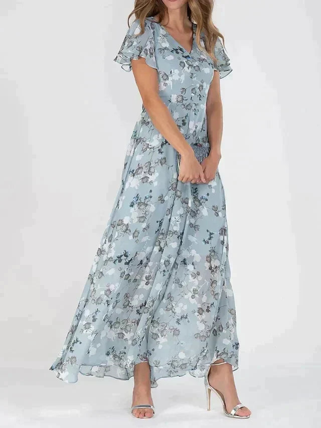 "Elegant blomstret maxi kjole med V-hals og flydende silhuet, ideel til kvinder, der søger et moderne og feminint look."