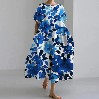 "Farverig blomsterkjole i pastelnuancer med flatterende silhuet, ideel til forårsbegivenheder og afslappet brug."