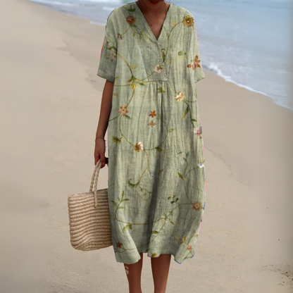 "Luftig blomster sommerkjole med V-hals og farverigt mønster, ideel til varme dage for et frisk og sommerligt look."