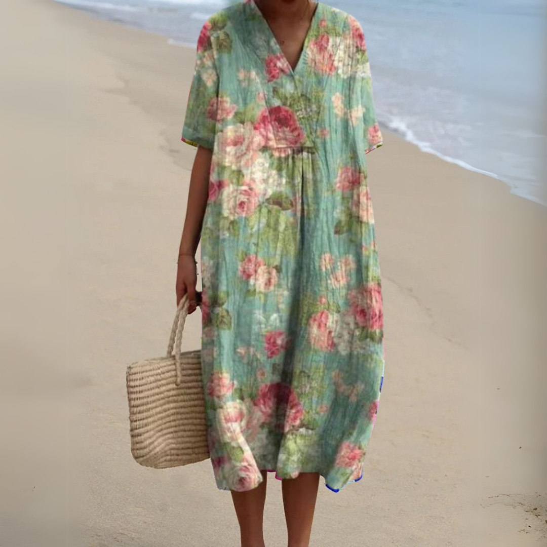 "Luftig blomster sommerkjole med V-hals og farverigt mønster, ideel til varme dage for et frisk og sommerligt look."