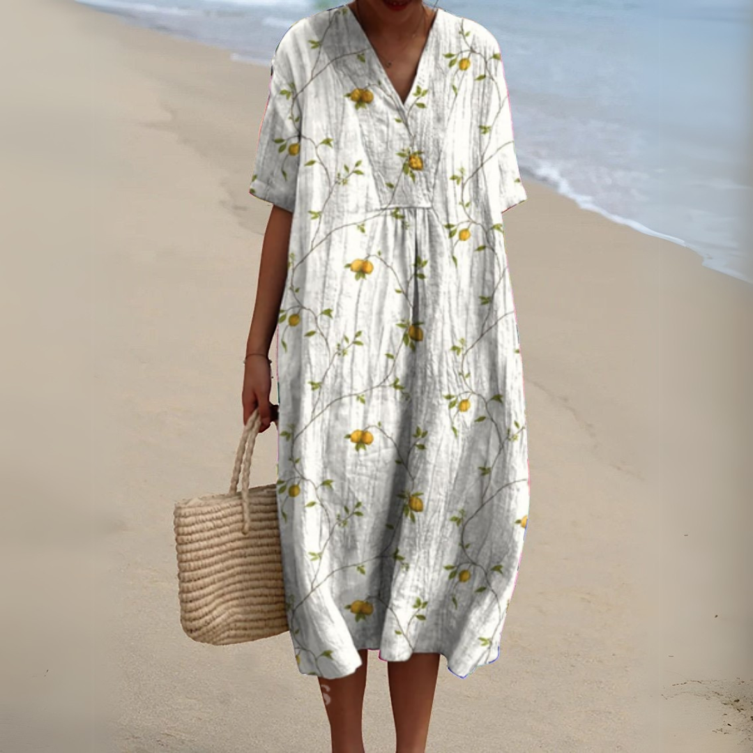 "Luftig blomster sommerkjole med V-hals og farverigt mønster, ideel til varme dage for et frisk og sommerligt look."