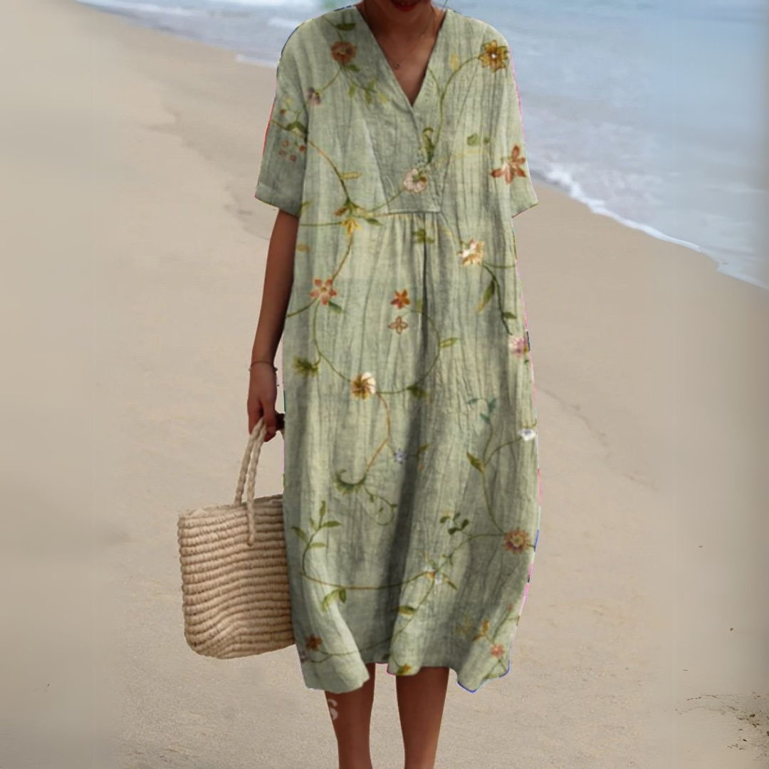 "Luftig blomster sommerkjole med V-hals og farverigt mønster, ideel til varme dage for et frisk og sommerligt look."