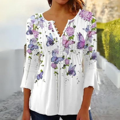 "Mønstret dameskjorte i silkeagtigt stof, perfekt til hverdag og fest, viser elegant design og blød tekstur."