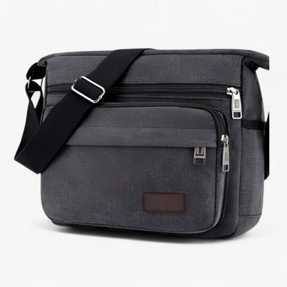 "Multifunktionel canvas skuldertaske til mænd med justerbar rem og rummelige lommer til daglig brug."