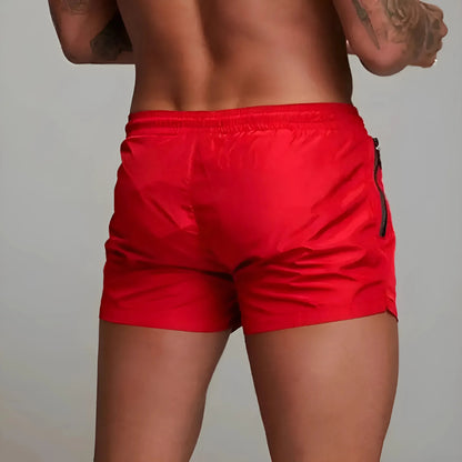 "Røde hurtigtørrende herre badeshorts med lommeklap, justerbar snøre og elastisk linning"