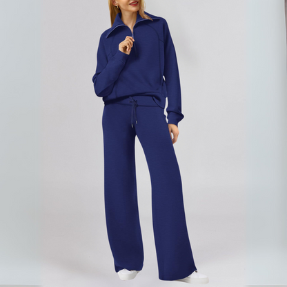 "Stilfuld joggingdragt med lynlåstrøje og brede bukseben i blødt stof, ideel til både afslapning og hverdagsbrug."