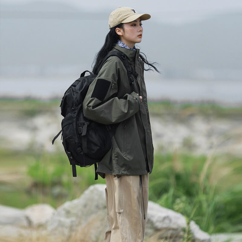 "Vind- og vandtæt damejakke i moderne design, stilfuld sort overflade, ideel til regnfulde vejrforhold."